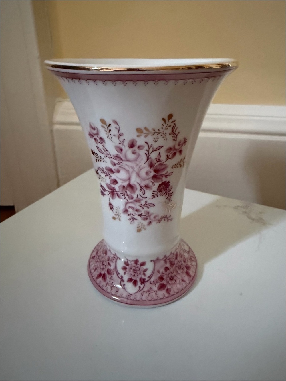 A vintage fluted vase w raspberry floral motif.